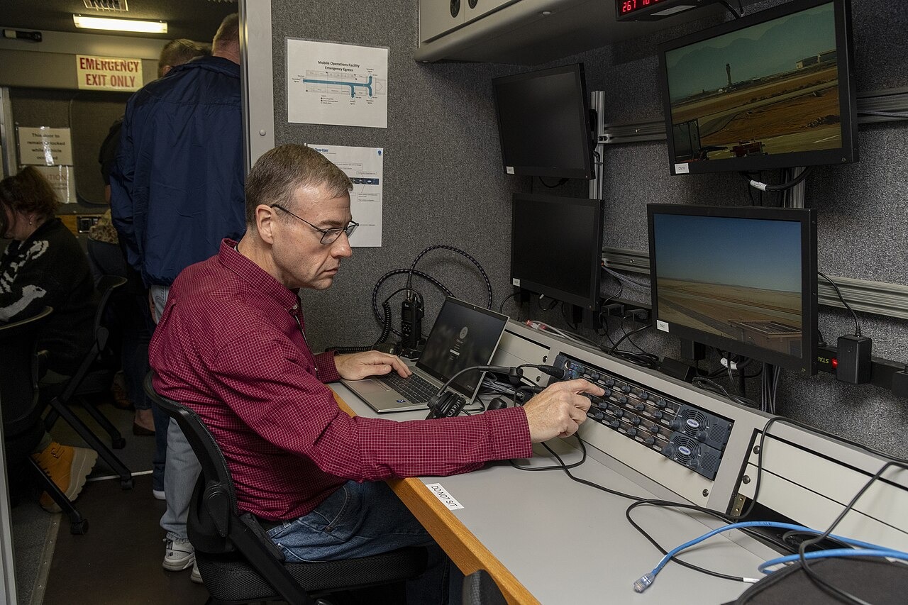File photo: NASA researcher Dennis Iannicca adjusts a control board in the Mobile Operations Facility at NASA’s Armstrong Flight Research Center while gathering ADS-B data during advanced-air-mobility test-flight research. Illustrative context; not a photograph of the reported event.